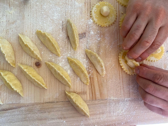 Gnocchi di patate farciti al pecorino, fave e guanciale, cipolla rossa salsa all'uovo arancia e tartufo nero