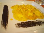Ravioli ripieni di ricotta con salsa di zucca e scampi ed emulsione di nero di seppia