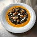 -Fregola al nero di seppia, mantecata con crema di zucca e cozze - -