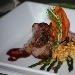Medaglione di porchettone alle erbe della macchia mediterranea laccato con salsa al monica, servito sul crema di patate ed accompagnato da asparagi caramellati con noci croccanti  - -